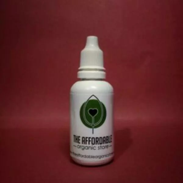 A bottle of 30 ml neem oil kept against a red background