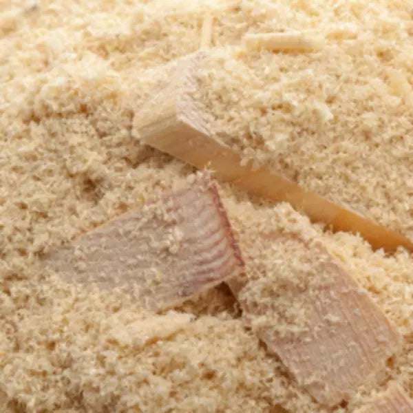 This is an image of finest powder of Wood saw dust along with some small pieces of woods on it.