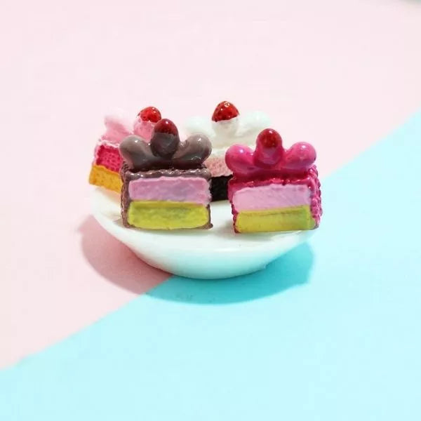 A cute different Miniature Dollhouse Pastry kept on a miniature white plate.