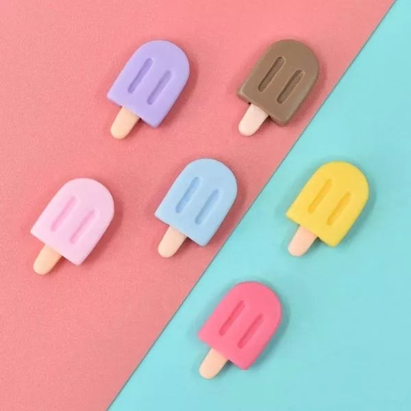 A set of Miniature Dollhouse Ice Cream kept on a blue and pink paper.