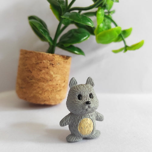 A single squirrel kept against a little plant.