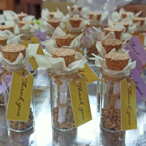 Multiple seed gift bottles with a thank you note attached