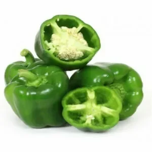 Several green capsicums, whole and cut in half, against a white background