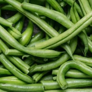 Several long green beans in a heap