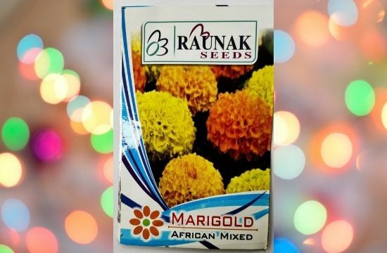 A packet of Raunak Seeds Marigold African Mix in a colorful background