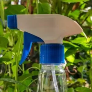 This is an image of Water Spray Gun with greenery in the background.