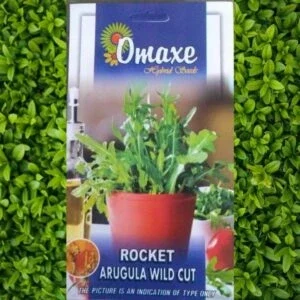 A packet of Omaxe Rocket Arugula Wild Cut Seeds kept against a leafy background.