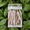 This is an image of a packet of Biocarve Radish White Seeds kept against a green leafy background.