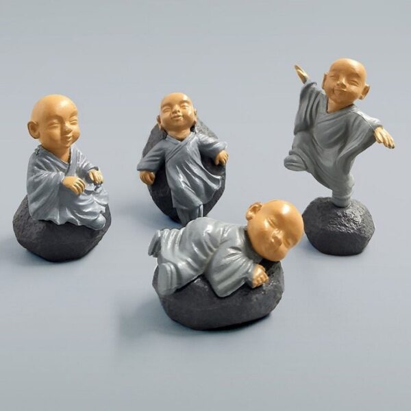 A cute and different posture Miniature Chinese Feng Shui Monks on a surface.