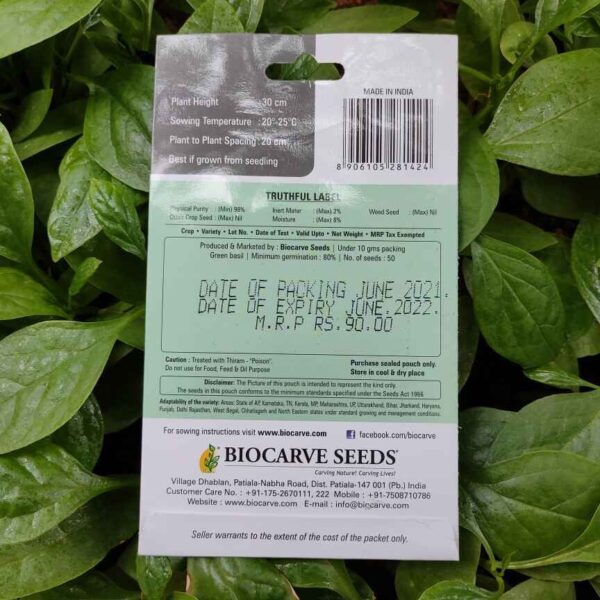Backside picture of Biocarve Basil Green packet with leaves in background