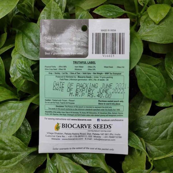 Backside picture of Biocarve Field Peas Seeds packet with leaves in background