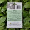 Backside picture of Biocarve petunia dwarf mix seeds packet with leaves in background