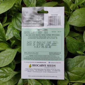 Backside picture of Biocarve Vinca Dwarf Mix Seeds packet with leaves in background
