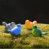 A cute and colorful Miniature Birds on a lawn grass.