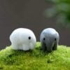 A cute and small Miniature Elephant on an artificial grass.