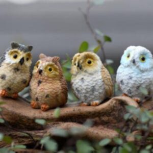 A bunch of miniature owls in a branch.