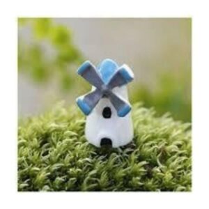 A cute and small Miniature Windmill on an artificial grass.