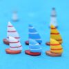 A cute multiple Miniature boat on a blue surface with blur background.