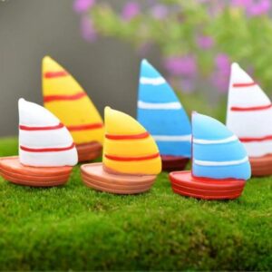 A cute multiple Miniature boat on a grass with blur background.