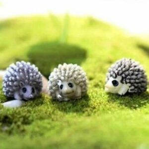 Small and cute three different colors Miniature Porcupines on a lawn grass.