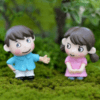 A cute Miniature Shy Couple on a grass with blur background.