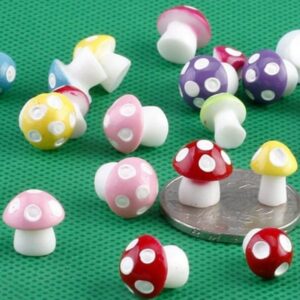 Several similar cute Miniature Mini Resin Mushroom on a green mat.