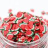 Several similar Miniature Polymer Clay Watermelon in a glass container.
