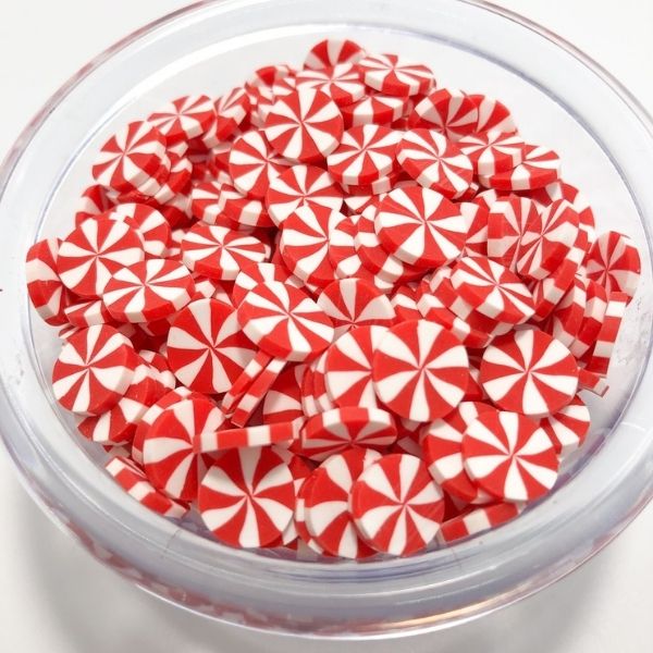 A multiple red Miniature Polymer Clay Candy in a glass bowl.