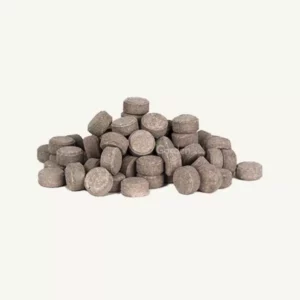 This is an image of a heap of organic plant food tablets kept against white color background.