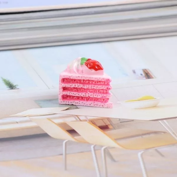 A single colorful Miniature Dollhouse Pastry kept on a cardboard.