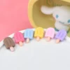 A set of colorful Miniature Dollhouse Ice Cream kept on a plate with a doll in the background.