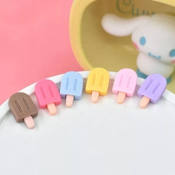 A set of colorful Miniature Dollhouse Ice Cream kept on a plate with a doll in the background.