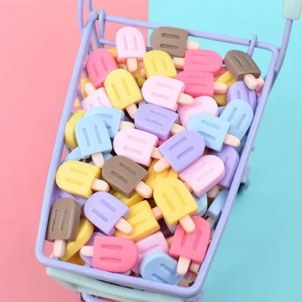 A set of Miniature Dollhouse Ice Cream in a small trolley with blue and pink background.