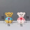This is an image of two Miniature Teddy Bears kept against grey color background.
