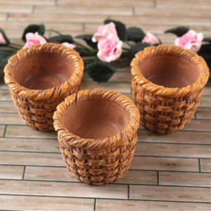 This is an image of three brown color Miniature Baskets with flowers in the background.