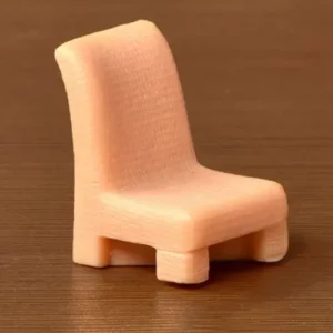 This is an image of light pink color Miniature Toy Chair against brown background.