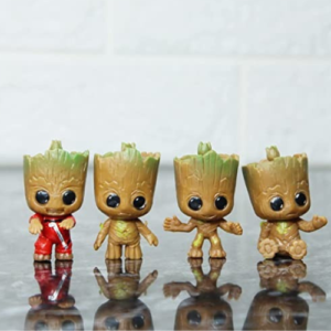 This is an image of four Miniature Groot kept on top of glass with their reflection falling on the glass.